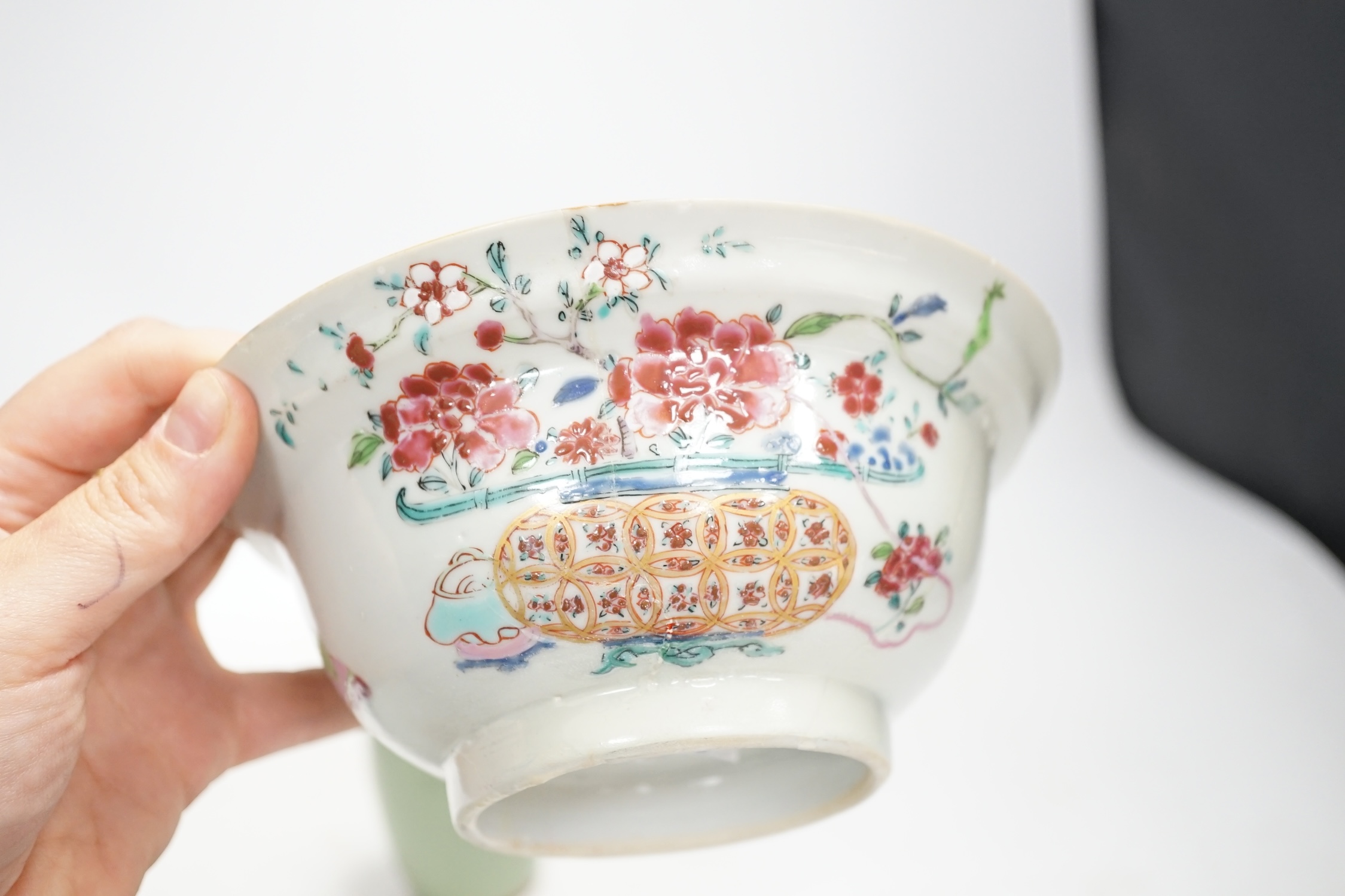 A Chinese famille rose bowl, an Imari patterned bowl, a small blue glazed vase and a similar celadon glazed vase, 18th century and later. Condition - both bowls badly cracked, overall poor